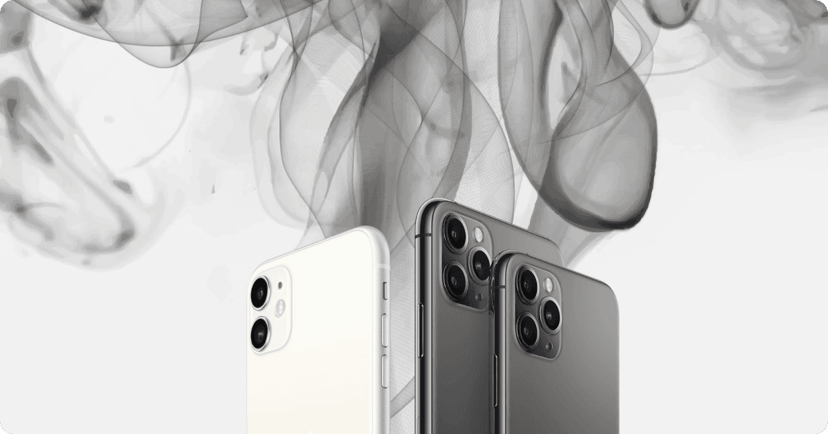 Three iPhones side by side with polluted smoke rising from them
