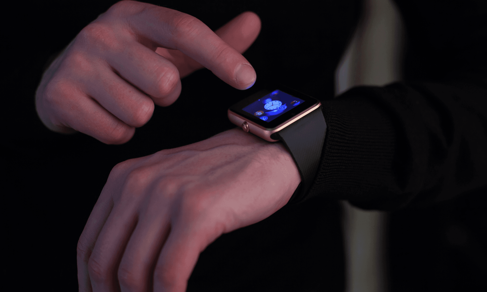 Close-up shot of a person's hands wearing a smartwatch.